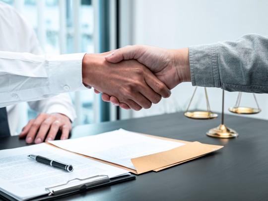 Lawyer and client shaking hands