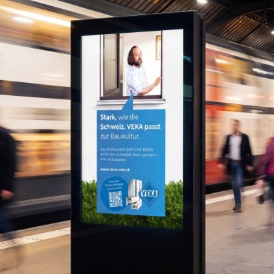 B2C campaign poster at a train station in Switzerland